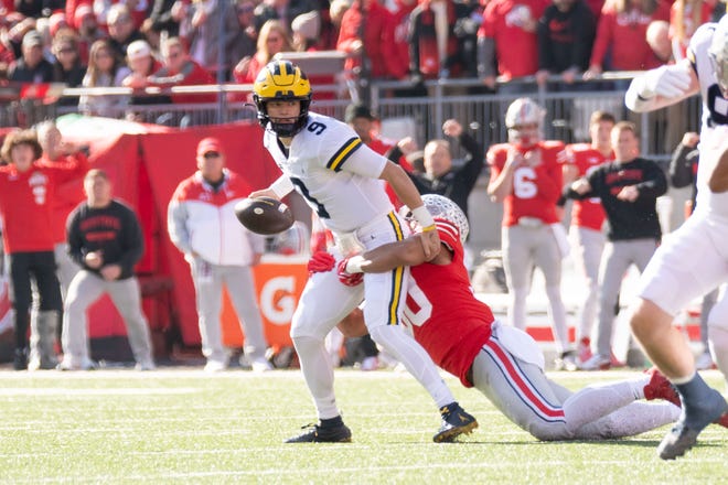 Michigan quarterback J.J. McCarthy received an intentional grounding penalty on this play while being tackled by Ohio State linebacker Cody Simon during the first quarter.