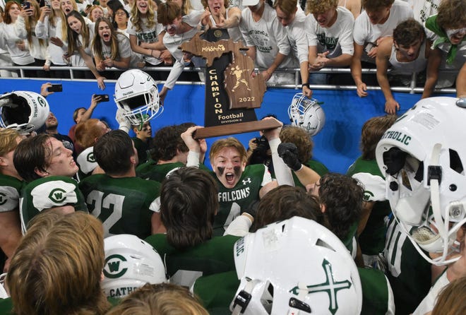 Grand Rapids West Catholic celebrates its Division 6 state championship following a 59-14 win over Negaunee at Ford Field in Detroit on Friday, Nov. 25, 2022.