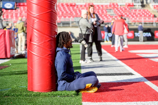 Michigan running back Donovan Edwards sits quietly in one of the end zones before the game against Ohio State.