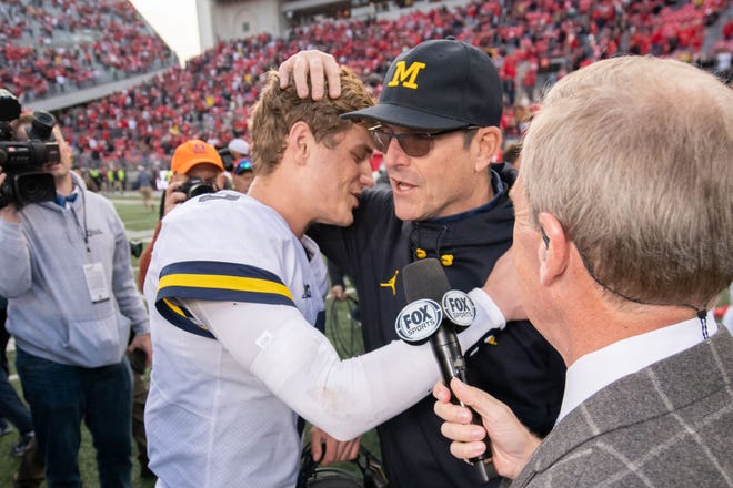 Michigan quarterback J.J. McCarthy gets a hug from head coach Jim Harbaugh after the 45-23 win over Ohio State.