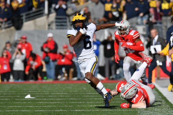 Michigan's Cornelius Johnson (6) evades Ohio State's Jack Sawyer (33) on this long touchdown reception in the second quarter.