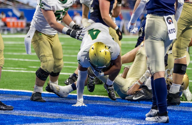 Lumen Christi running back Derrick Walker (4) stumbles into the end zone for his team's second touchdown in the fourth quarter. It proved to be the winning score as the Lumen Christi scored 15 unanswered points in the final quarter.