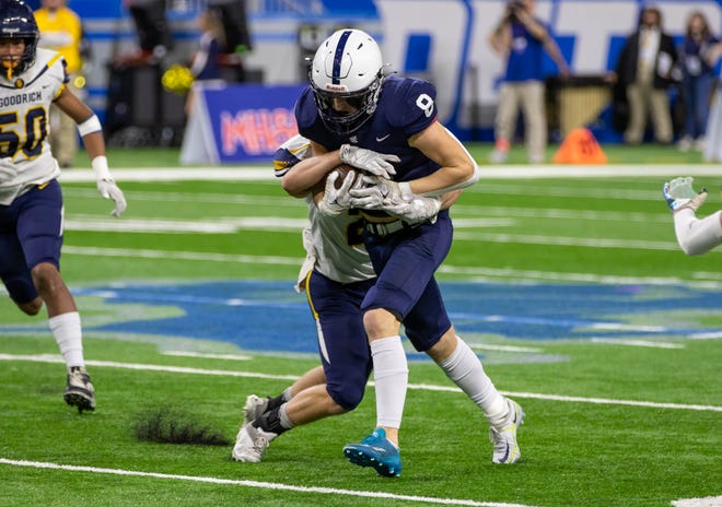 Grand Rapids South Christian running back Nate Brinks (8) is slowed down by a Goodrich defender in the first half of the Division 4 state title game at Ford Field in Detroit on Friday, Nov. 25, 2022.