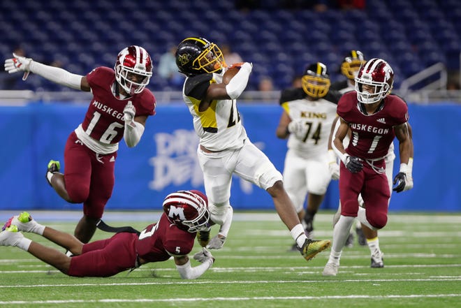 Detroit Martin Luther King senior defensive back Jacobe Oglesby (22) runs the ball during the first half of the Division 3 MHSAA championship game against Muskegeon Saturday, Nov. 26, 2022, at Ford Field in Detroit. King won the game, 56-27.