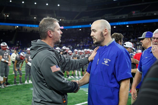Frankenmuth head coach Phil Martin shakes hands with Gladwin head coach Marc Jarstfer at the conclusion of the Division 5 state final.