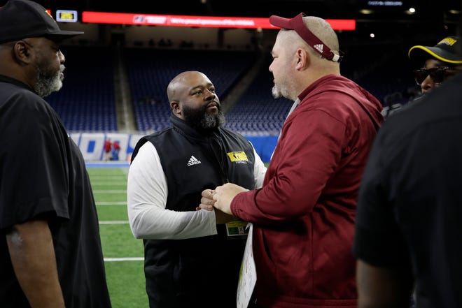 Detroit Martin Luther King head coach Tyrone Spencer shakes hands with Muskegeon SHane Fairfield after the second half of the division 3 championship game against Muskegeon Saturday at Ford Field. Photo by: Brian Sevald / Special to the Detroit News