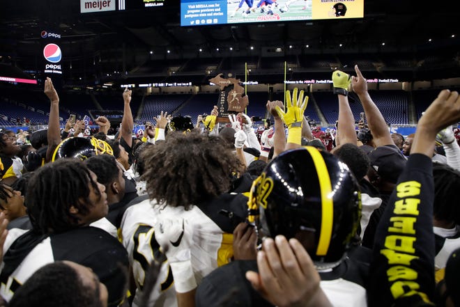 Detroit Martin Luther King's players celebrate their divsion 3 championship win at the conclusion of the game against Muskegeon Saturday at Ford Field.