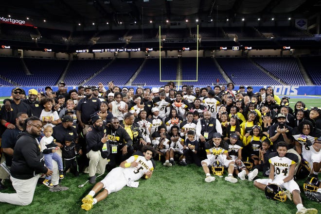 Detroit Martin Luther King's players pose for a photo at the conclusion of the game against Muskegeon Saturday at Ford Field.