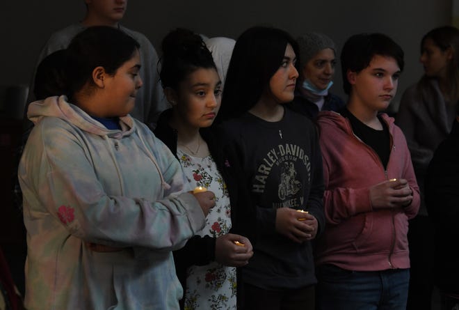 Aiya Alkhativ, 12, Liana Llamas, 13, Yulissa Ascencio, 13, Camden Williams, 13  listen in during a Dearborn PTA Council vigil in remembrance for those impacted by last year's shooting at Oxford High School at Dearborn Public Schools Administrative Service Center in Dearborn, Michigan on November 30, 2022.