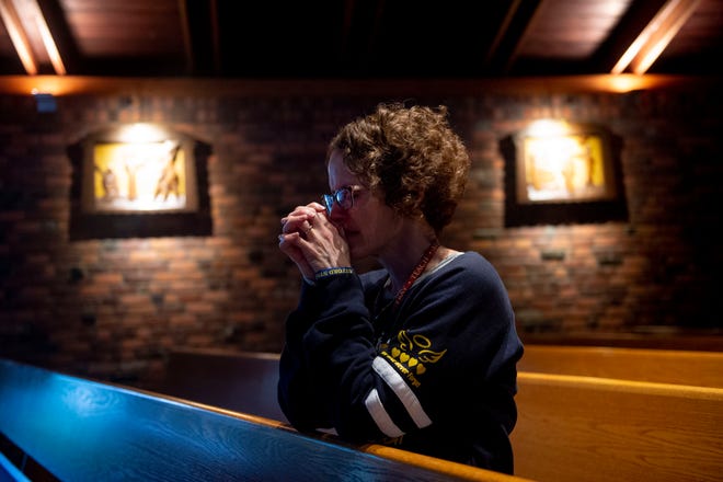 Suzie Fazzini prays alone in a pew on Wednesday, Nov. 30, 2022, at St. Joseph Catholic Church in Lake Orion, Mich.