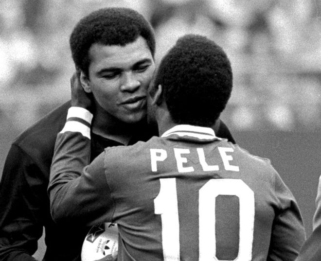 In this Oct. 1, 1977 file photo, Pele embraces U.S. boxer Muhammad Ali during a ceremony honoring the Brazilian soccer star who plays for the New York Cosmos at Giants Stadium in East Rutherford, N.J., before Cosmos' 2-1 victory over Brazil's Santos, the final game of Pele's career, in which he played on both sides, one each half.