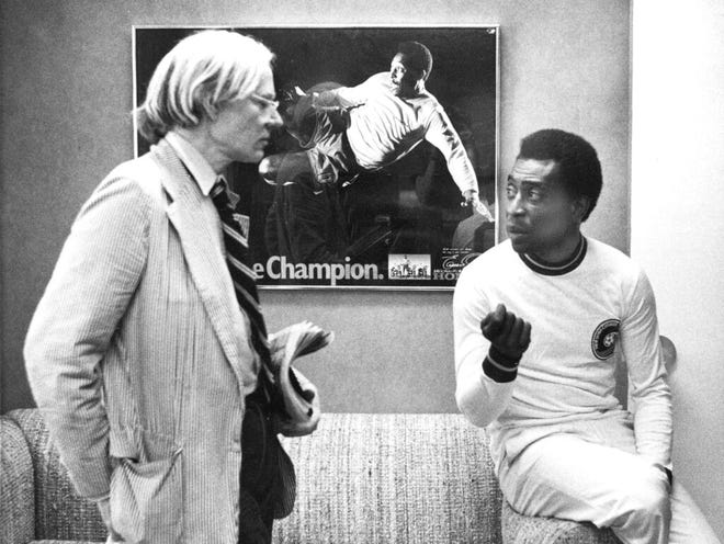 In this  July 26, 1977 file photo, surrealist artist Andy Warhol speaks with Brazil's soccer player Pele about a portrait after Warhol was commissioned to make a series of portraits of athletic stars in New York.