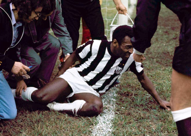 Famed Brazilian soccer star, Pele, Edson Arantes do Nascimento, is hurt during a game Sept. 29, 1974. Pele retired Oct. 2 in Santos, Brazil and made a comeback in 1975 with the New York Cosmos. (AP Photo)