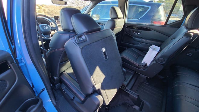 With the push of a button at bottom (or top), the second-row seat of the 2023 Honda Pilot TrailSport collapses forward for easy third-row access.