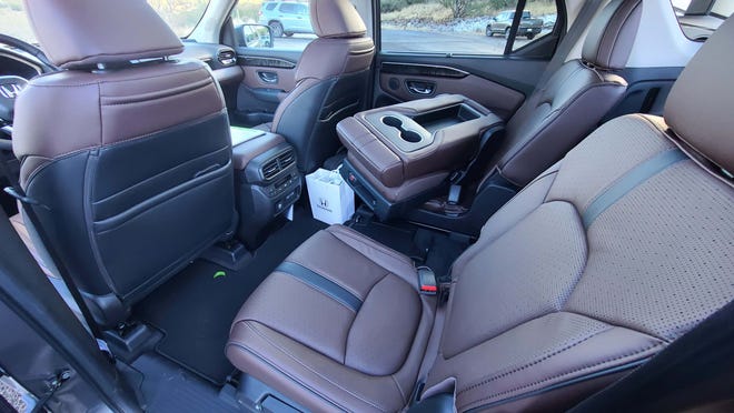 In the second row of 2023 Honda Pilot models equipped with a bench seat, the middle portion can be used a seat, cupholder, or can be removed entirely (as shown here).