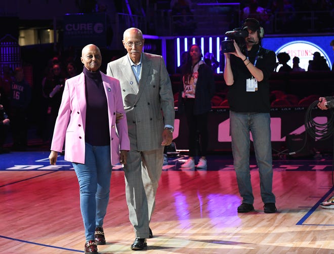 Former Pistons great Dave Bing escort Geraldine Lanier Stewart, (Bob Lanier sister), on the court for the halftime  ceremony to honor Bob Lanier.