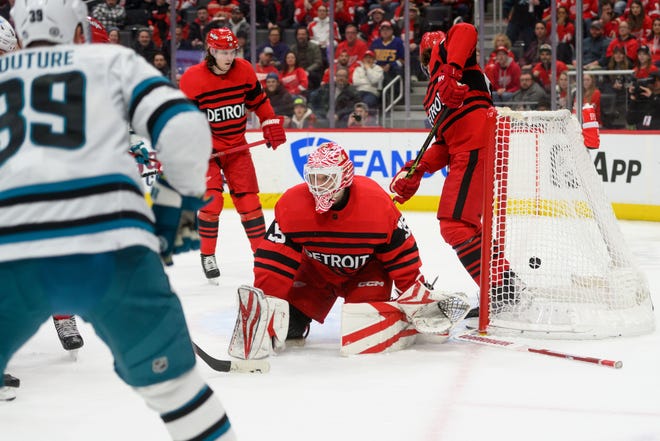 A shot by San Jose center Logan Couture slips past Detroit goaltender Ville Husso for a goal during the second period.