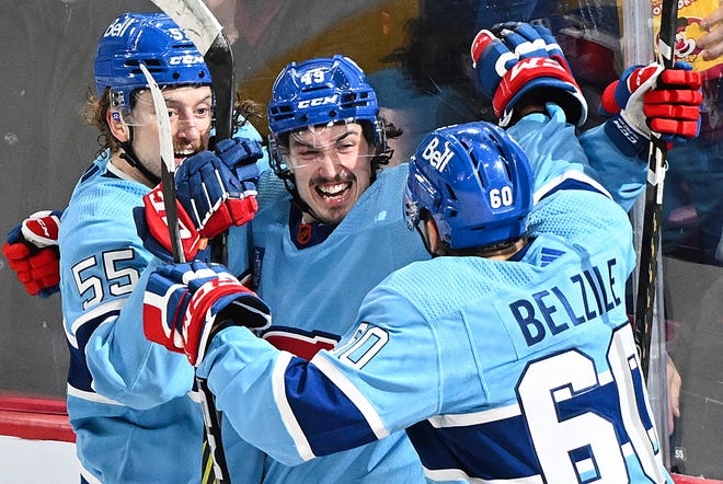 Montreal Canadiens' Rafael Harvey-Pinard (49) celebrates with teammates Michael Pezzetta (55) and Alex Belzile after scoring against the Detroit Red Wings during second-period.