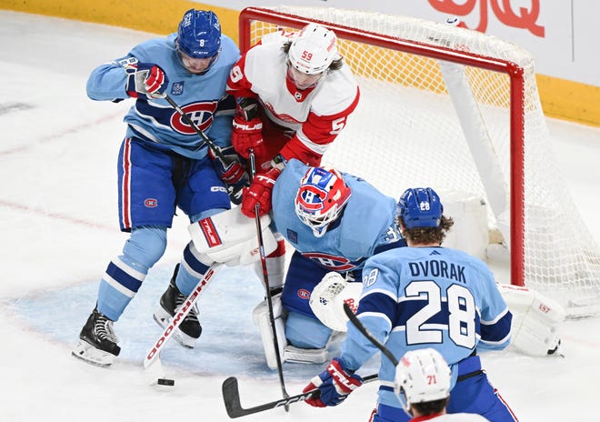 Detroit Red Wings' Tyler Bertuzzi (58) moves in against Montreal Canadiens goaltender Jake Allen as Canadiens' Mike Matheson (8) and Christian Dvorak defend during first-period.