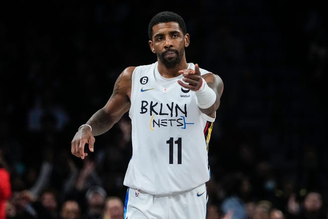Brooklyn Nets' Kyrie Irving gestures to a teammate during the first half.