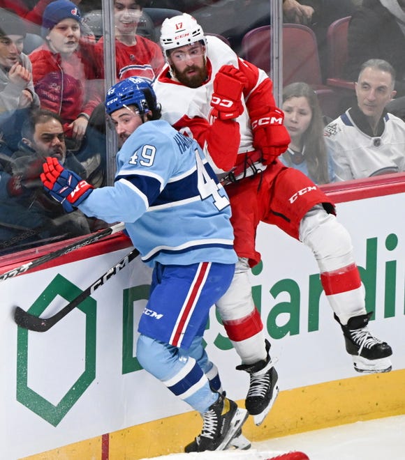 Montreal Canadiens' Rafael Harvey-Pinard (49) checks Detroit Red Wings' Filip Hronek into the boards during first-period NHL hockey game action in Montreal, Thursday, Jan. 26, 2023.