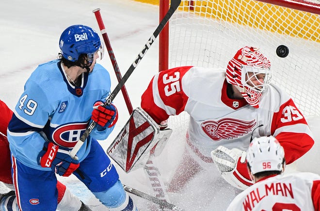 Montreal Canadiens' Rafael Harvey-Pinard (49) scores against Detroit Red Wings goaltender Ville Husso as Red Wings' Jake Walman (96) watches during the second period of an NHL hockey game Thursday, Jan. 26, 2023, in Montreal.