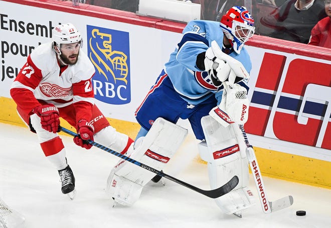 Detroit Red Wings' Michael Rasmussen challenges Montreal Canadiens goaltender Jake Allen for the puck during first-period.