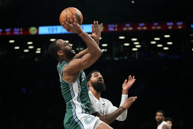 Detroit Pistons' Alec Burks, left, shoots next to Brooklyn Nets' Markieff Morris during the second half of an NBA basketball game Thursday, Jan. 26, 2023 in New York.