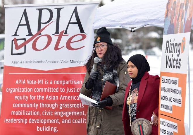 Jasmine Rivera, left, of Ferndale, co-executive director of Rising Voices, and Rebeka Islam of Sterling Heights, executive director of APIA Vote Michigan, address the crowd.