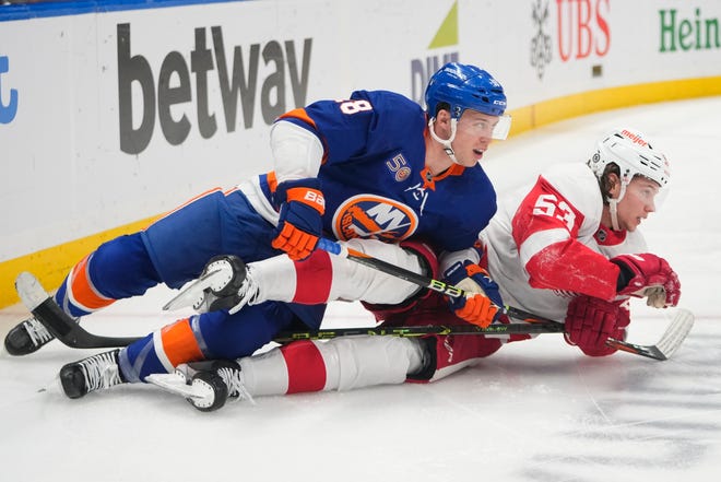 New York Islanders' Anthony Beauvillier (18) and Detroit Red Wings' Moritz Seider (53) fall down while fighting for postion during the second period.