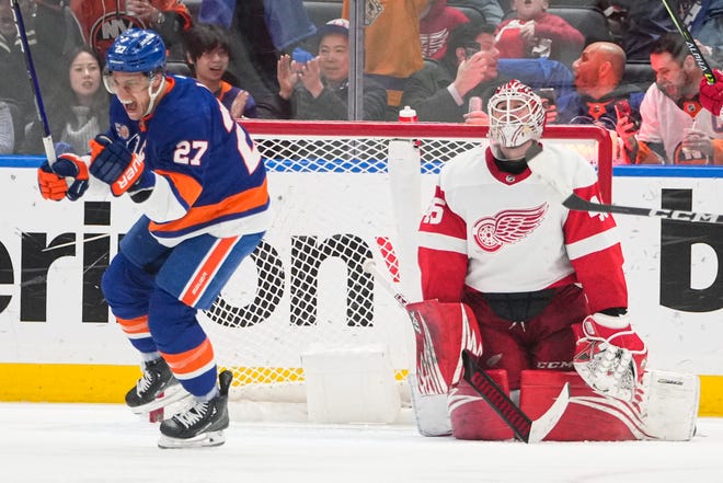 New York Islanders' Brock Nelson, left, celebrates as Detroit Red Wings goaltender Magnus Hellberg, right, reacts after Brock Nelson scored a goal during the third period of an NHL hockey game Friday, Jan. 27, 2023, in Elmont, N.Y. The Islanders won 2-0.