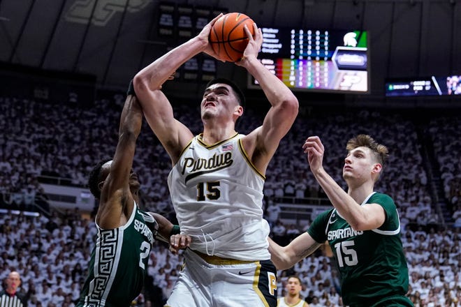 Purdue center Zach Edey (15) shoots between Michigan State guard Tyson Walker (2) and center Carson Cooper (15) during the second half.
