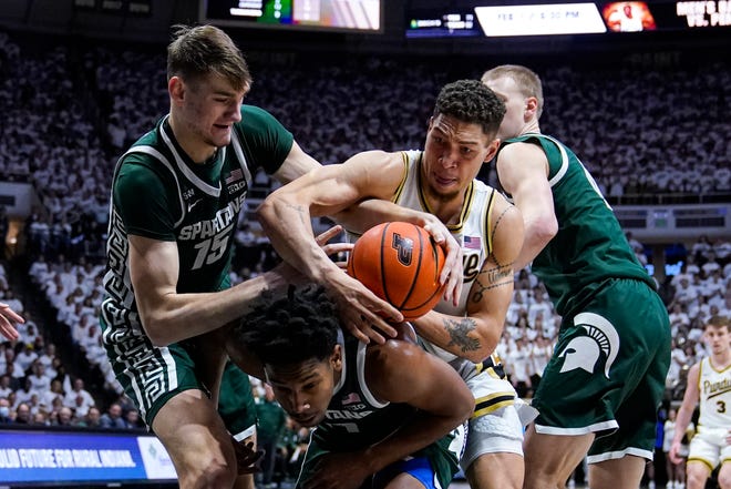 Purdue forward Mason Gillis (0) fights for a rebound with Michigan State center Carson Cooper (15) over guard A.J. Hoggard (11) during the second half.