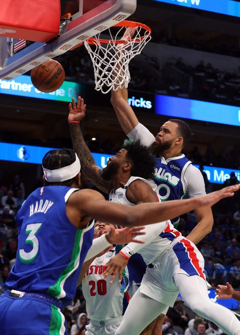 Detroit Pistons forward Saddiq Bey, center, shoots against Dallas Mavericks center JaVale McGee, right, and guard Jaden Hardy (3) in the first half of an NBA basketball game Monday, Jan. 30, 2023, in Dallas.