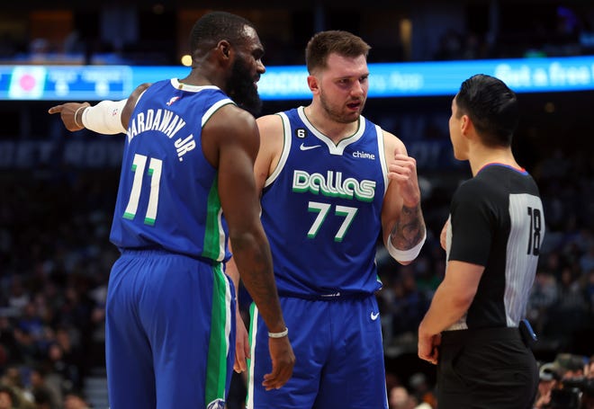 Dallas Mavericks forward Tim Hardaway Jr. (11) and guard Luka Doncic (77) argue a call with referee Evan Scott (78) in the first half of an NBA basketball game against the Detroit Pistons, Monday, Jan. 30, 2023, in Dallas.