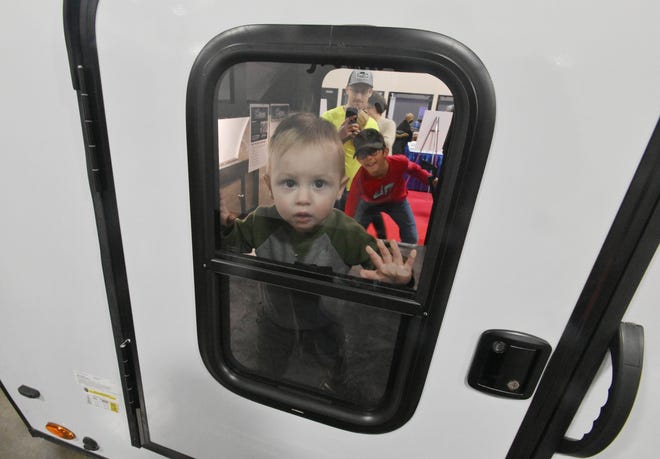 Miles Jackson, 16 months, peaks out the window of the perfectly kid sized RV, the Braton Creek - Bushwhacker 10HD.