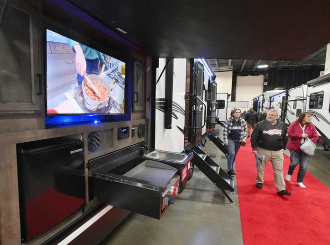 An exterior kitchen and entertainment center on the Venture RB - Sporttrek 332VBH draws the attention of visitors to the Marvac RV and Camping show.