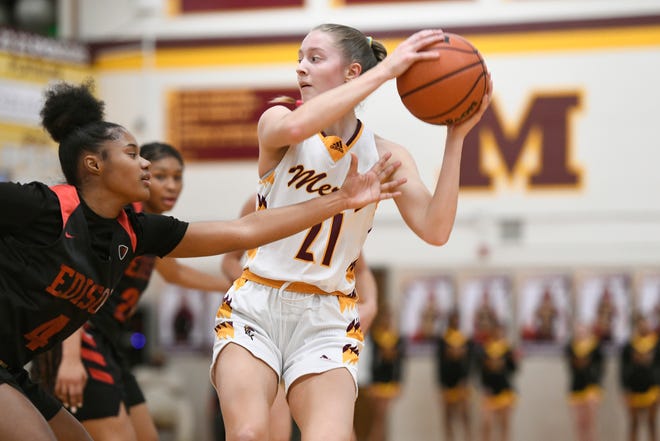 Farmington Hills Mercy’s Aizlyn Albanese, right, keeps the ball away from Detroit Edison guard Dakota Alston in the second quarter, Friday, Feb. 3, 2023, at Mercy HS in Farmington Hills, Mich.