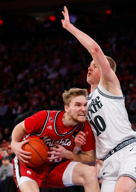 Rutgers guard Cam Spencer (10) drives to the basket against Michigan State forward Joey Hauser during the first half.
