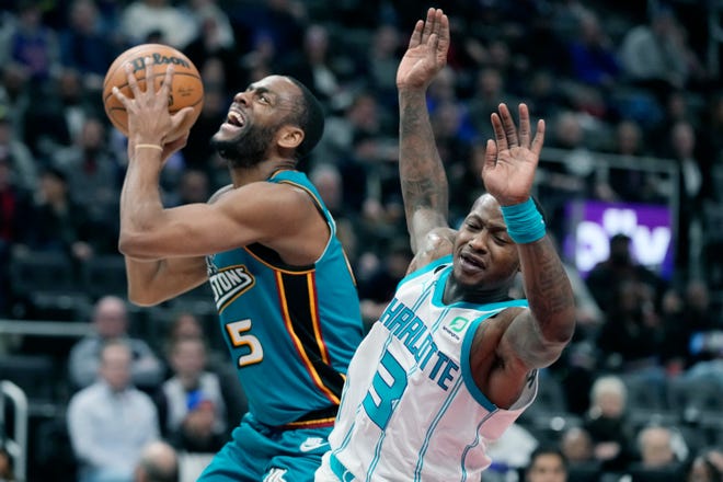 Detroit Pistons guard Alec Burks (5) is fouled by Charlotte Hornets guard Terry Rozier (3) during the first half of an NBA basketball game, Friday, Feb. 3, 2023, in Detroit.