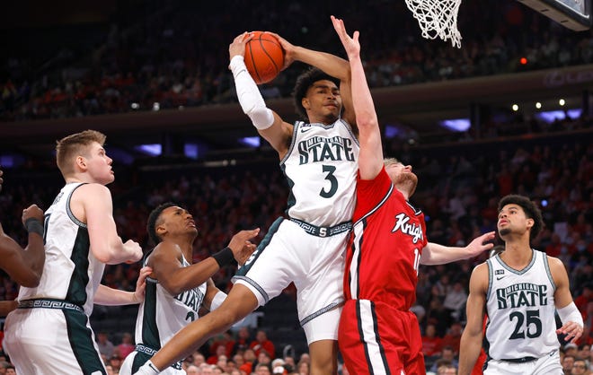Michigan State guard Jaden Akins (3) grabs a rebound against Rutgers guard Cam Spencer (10) during the first half.