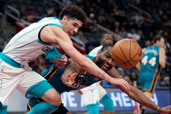 Charlotte Hornets guard LaMelo Ball (1) an dDetroit Pistons guard Alec Burks (5) chase the loose ball during the second half of an NBA basketball game, Friday, Feb. 3, 2023, in Detroit.