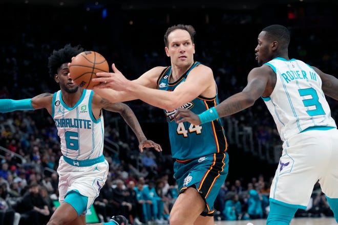 Detroit Pistons forward Bojan Bogdanovic (44) passes as Charlotte Hornets guard Terry Rozier (3) defends during the first half of an NBA basketball game, Friday, Feb. 3, 2023, in Detroit.