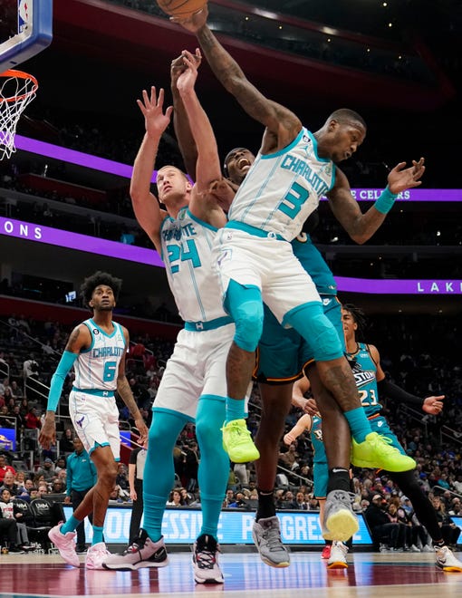 Charlotte Hornets center Mason Plumlee (24), guard Terry Rozier (3) and Detroit Pistons center Jalen Duren reach for the rebound during the first half of an NBA basketball game, Friday, Feb. 3, 2023, in Detroit.