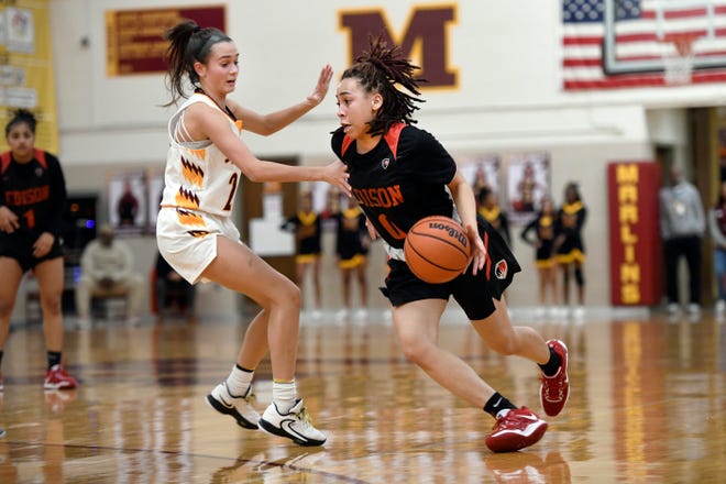 Detroit Edison guard Myana Cooksey, right, drives past Farmington Hills Mercy’s Lauren Smiley in the fourth quarter, Friday, Feb. 3, 2023, at Mercy HS in Farmington Hills, Mich.