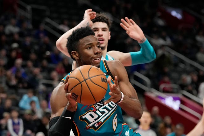 Detroit Pistons guard Hamidou Diallo (6) passes as Charlotte Hornets guard LaMelo Ball defends during the first half of an NBA basketball game, Friday, Feb. 3, 2023, in Detroit.