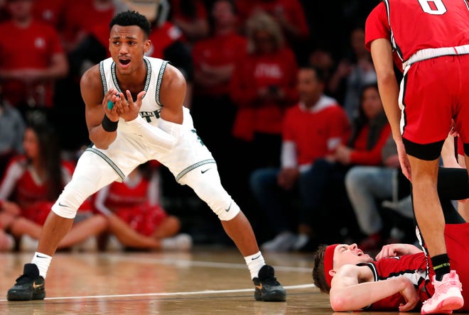 Michigan State guard Tyson Walker (2) reacts after committing a foul against Rutgers guard Paul Mulcahy, right, during the second half.