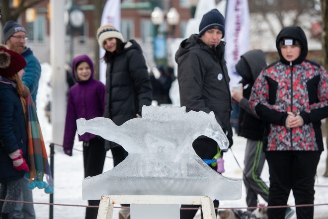 Throngs of visitors walk through the Plymouth Ice Festival in Plymouth, February 5, 2023.