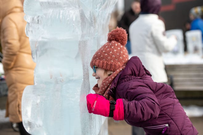 Eight-year-old Lucy Dely of Farmington Hills checks out the ice sculptures during the Plymouth Ice Festival in Plymouth, February 5, 2023.