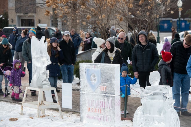 Throngs of visitors stream past the ice carvings during the Plymouth Ice Festival in Plymouth, February 5, 2023.
